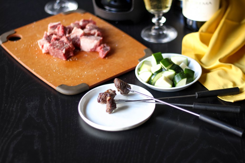 Preparing fondue with meat