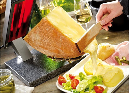 Swiss raclette fondue dish service